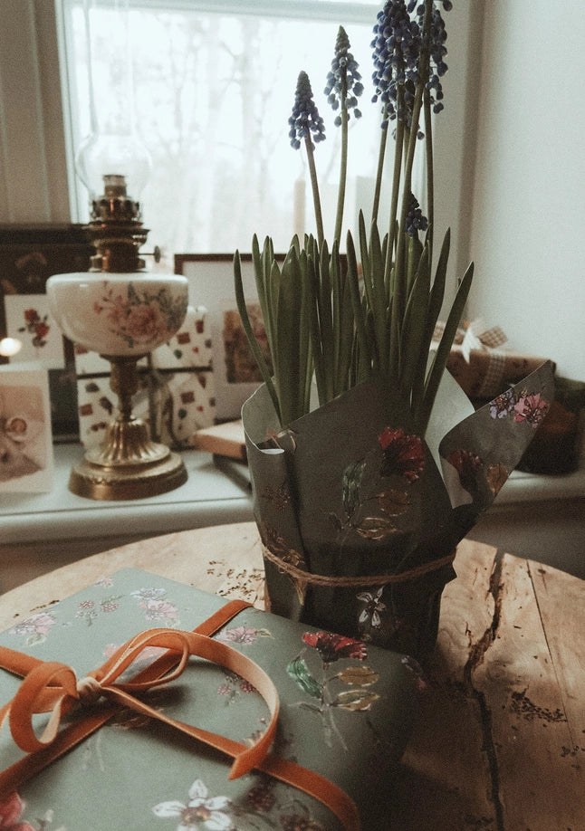 Juego de tres piezas de flores sobre papel de regalo gris oscuro